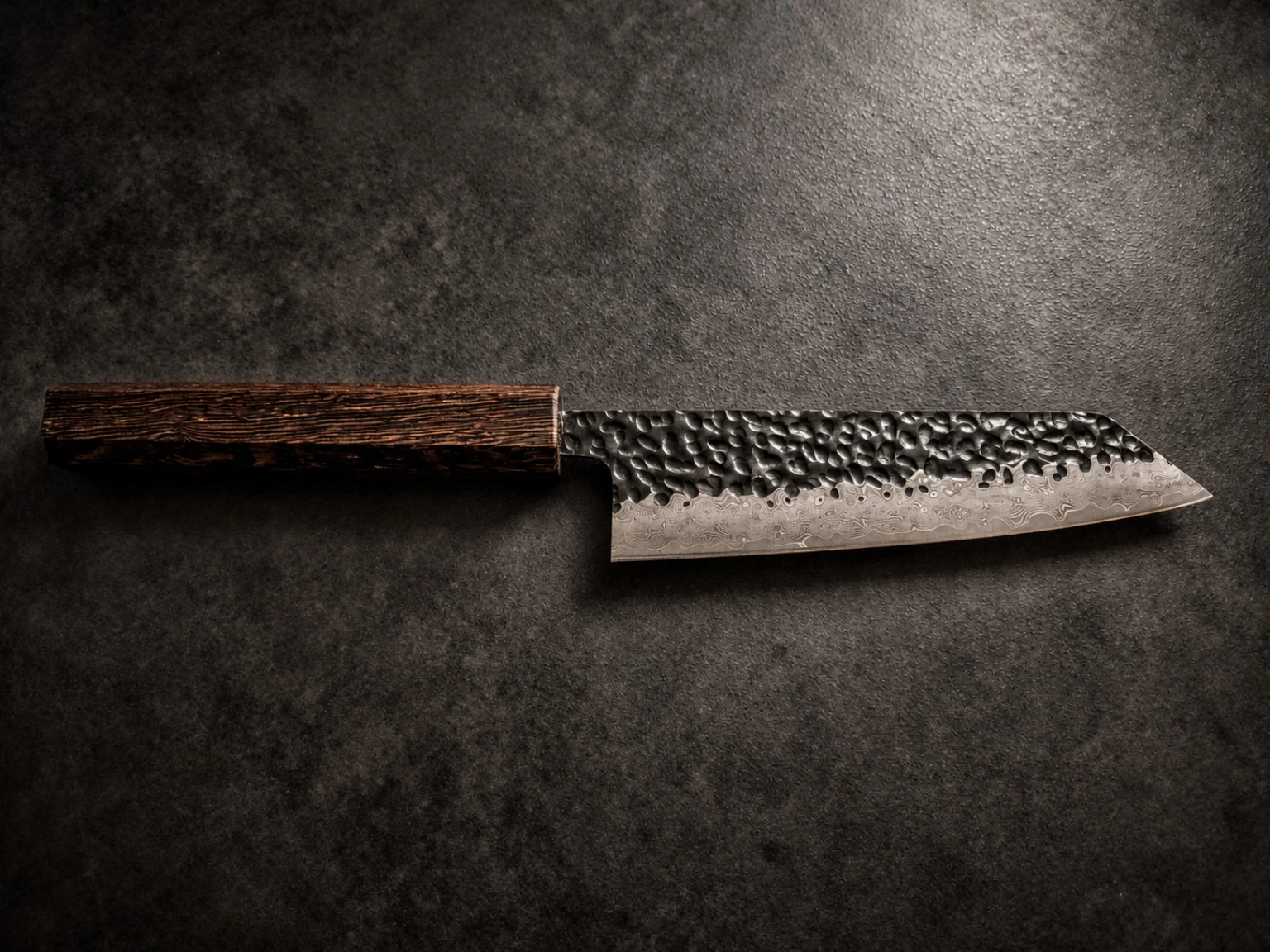 Finished knife — dark timber handle with warm copper-brown streaks