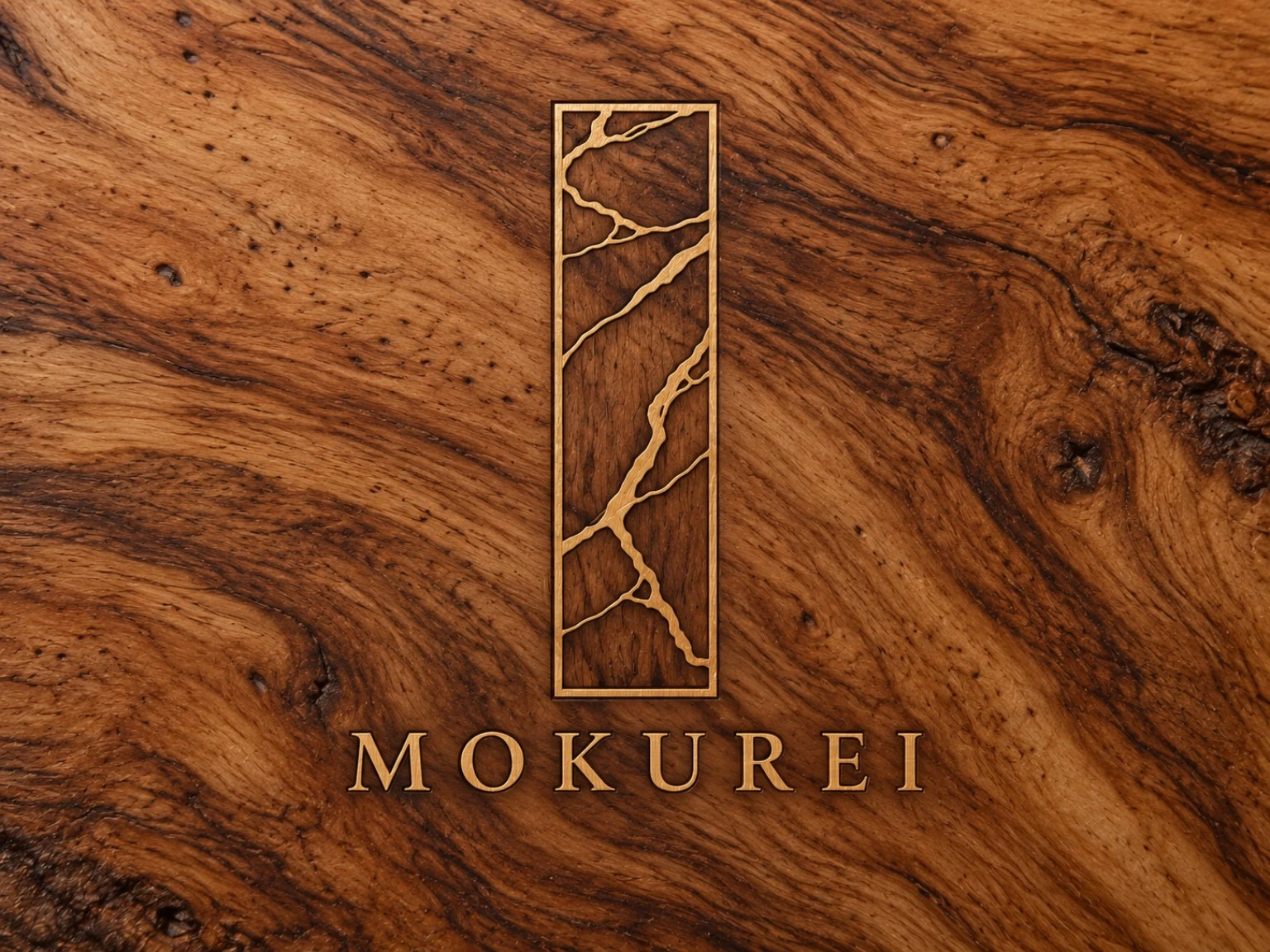 Mokurei brand inlay photographed on richly figured walnut, showing the signature rectangular mark and wordmark