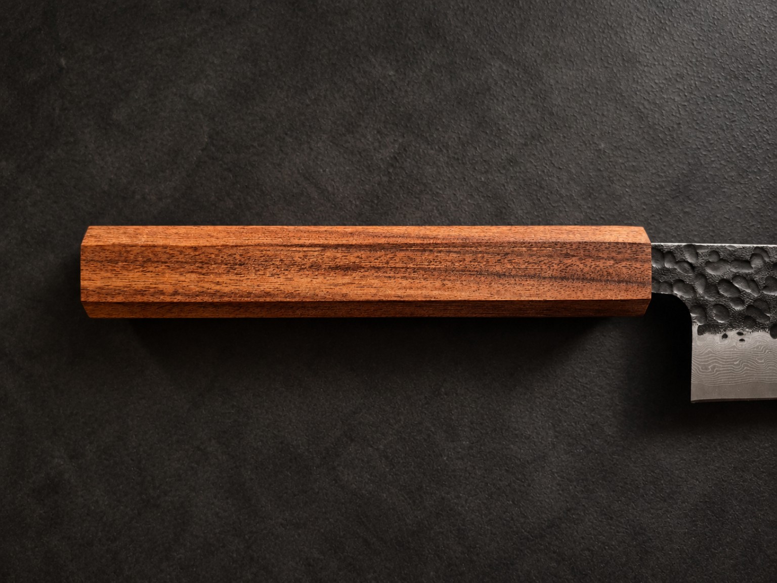 Close-up of the Mopane handle, revealing fine natural grain and reddish-brown tonal variation
