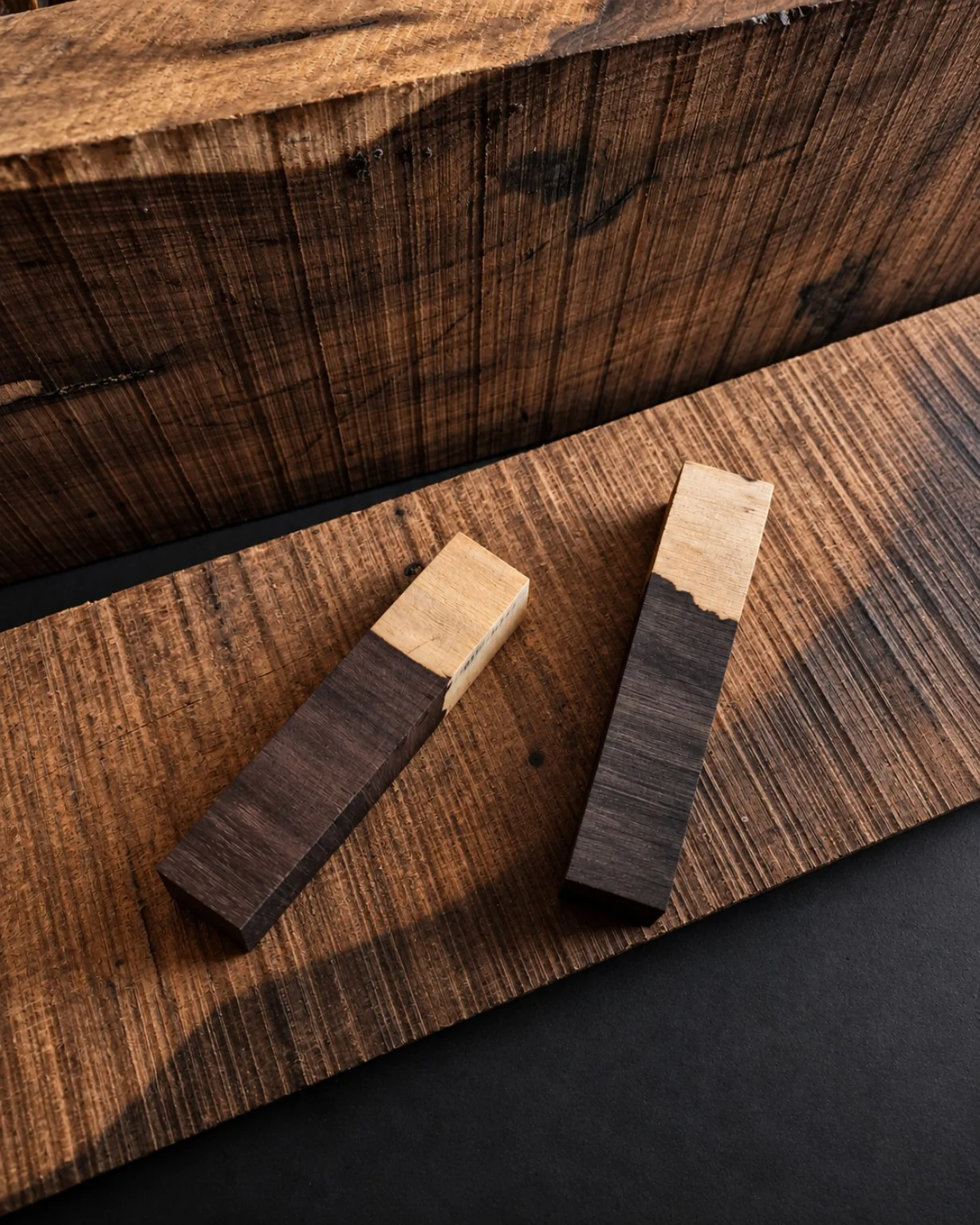 Sharp natural boundary between pale sapwood and dark heartwood in two timber blanks