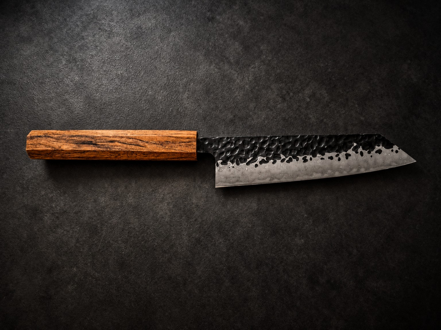 Complete 150 mm Kiritsuke Bunka kitchen knife with streaked golden-brown Teak wood handle and tsuchime hammered Damascus-pattern steel blade