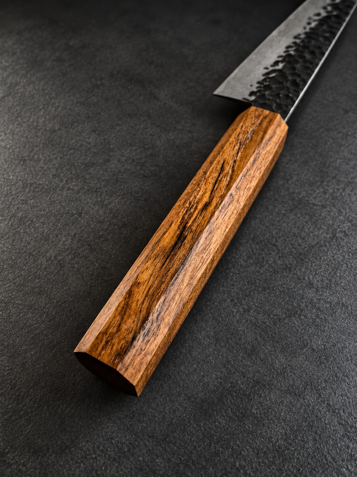 Perspective photograph of a wa-style Teak handle displaying elongated natural dark streaks