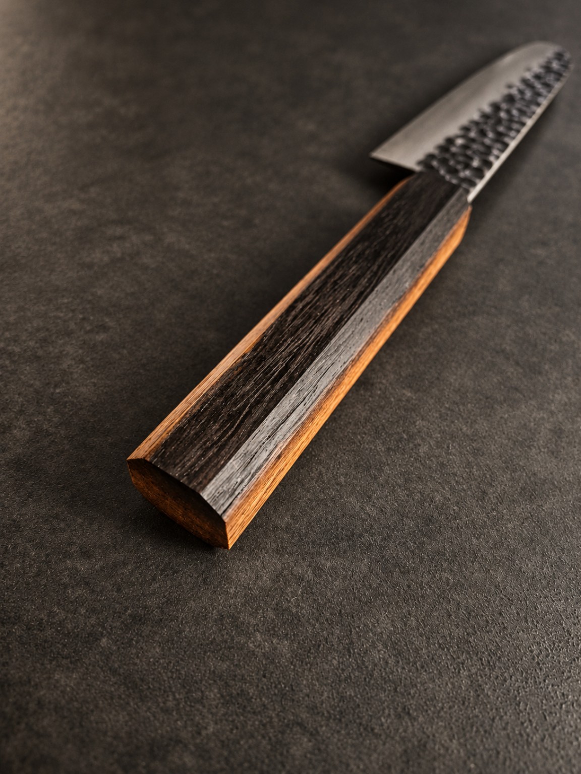 Perspective view along the Wenge heartwood and sapwood knife handle towards the steel blade